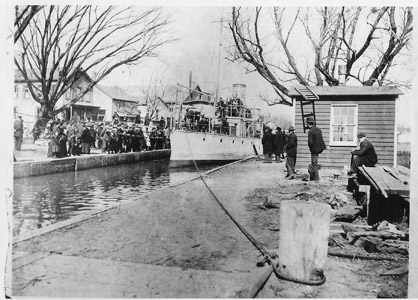 The Ex-Spanish Navy gunboat Alvarado draws a curious crowd in New Brunswick as it makes its way through the Delaware and Raritan Canal in 1899 on its way to the U.S. Navy base at Portsmouth, N.H.  The Alvarado was captured during the fall of Santiago de Cuba during the Spanish-American War.  She was ultimately used as a training ship at the United States Naval Academy before being struck from the Naval Register in 1912.